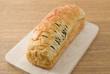 Loaf of Raisin Bread on A Wooden Cutting Board