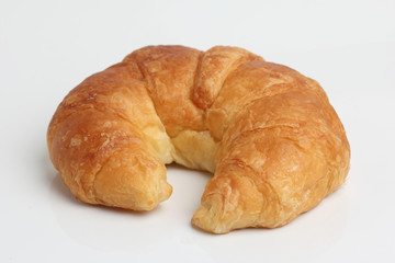one brown glod croissant isolated