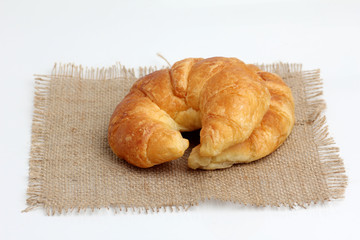croissant on spuare frayed burlap