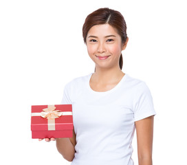 Young woman showing with present box