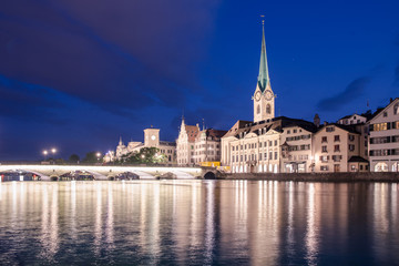 Fototapeta na wymiar Limmat riverside with famous church and clock tower, Zurich
