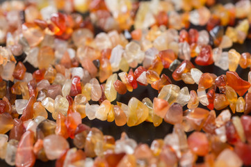A necklace of stone beads on a wooden surface close-up