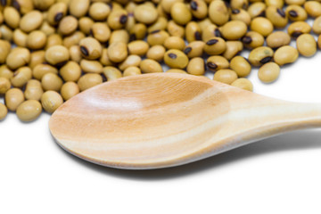 Empty wooden spoon near soybeans isolated