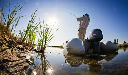 Meubelstickers man fishing on a lake © vitaliy_melnik