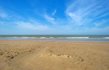 Fototapeta na wymiar Blue cloudy sky over a beach in summer