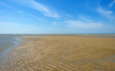 Blue cloudy sky over a beach in summer