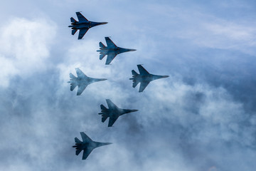 Silhouettes of russian fighter aircrafts SU-27 in the sky