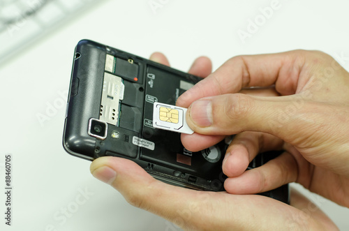 Inserting A Sim Card Into The Mobile Phone Stock Photo And Royalty