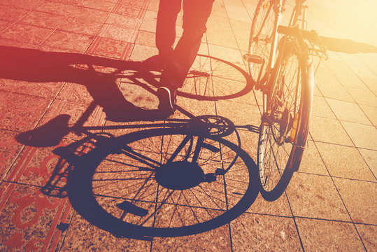 Fototapeta Shadow on Pavement, Man Pushing Bicycle