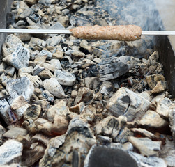cooking meat on the coals