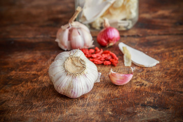 Garlic and onion organic herbs and spices on wooden background