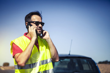 Man calling to insurance company after a car breakdown.