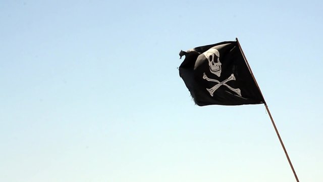 pirate flag waving with blue sea background in slow speed