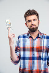 Man holding bill of USA dollar