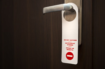 Do not disturb sign on closed door handle