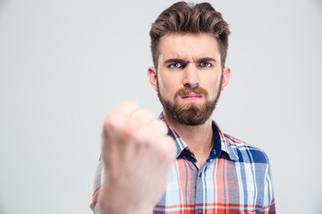 Fototapeta premium Handsome man showing fist at camera