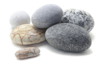 Fototapeta na wymiar Beautiful stones isolated on white background with shadow. Closeup grouped round stones. Studio photographed stones.