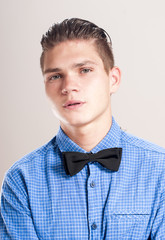 Refined man in a blue shirt with black bow tie