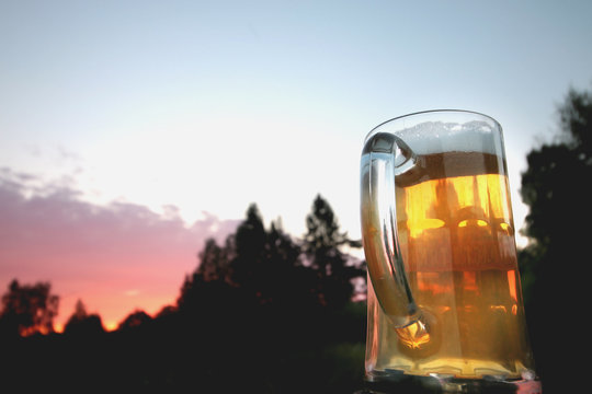 mug of beer at sunset