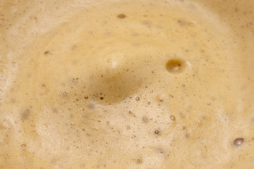 Close up of coffee cup. Isolated espresso foam. Drink morning coffee. Dark coffee foam. Macro image of coffee bubbles. 
