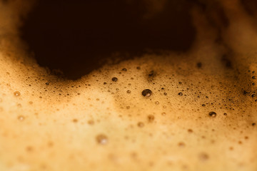 Close up of coffee cup. Isolated espresso foam. Drink morning coffee. Dark coffee foam. Macro image...