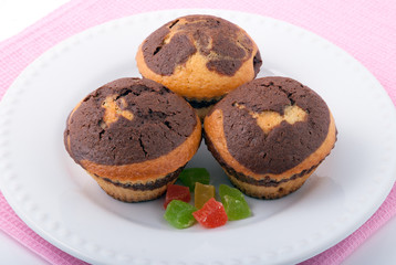 Three tasty muffins on a white plate