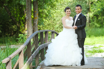 Wedding photo on wooden bridge