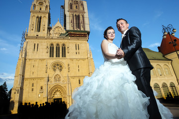 Newlyweds in front of Cathedral - Powered by Adobe