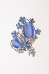 brooch with different gems on background.