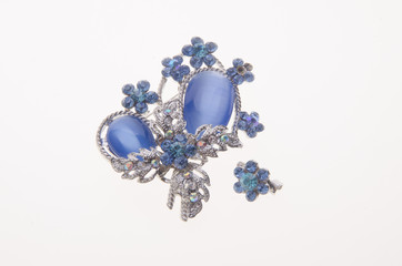 brooch with different gems on background.