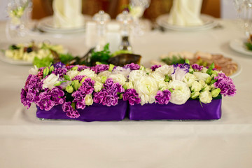 Beautiful flower composition on the wedding table 