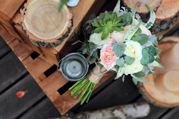 Bridal bouquet of roses on a wooden planks