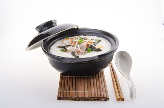 Traditional chinese pork porridge rice gruel served in claypot