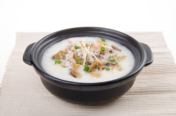 Traditional chinese pork porridge rice gruel served in claypot