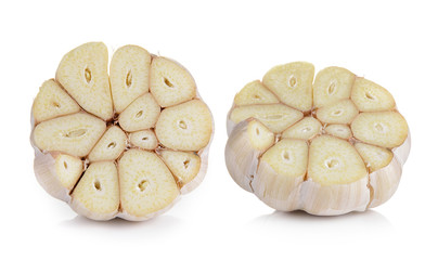 Head of garlic cut in half on white background