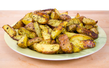 Plate full of baked potato on a wooden board