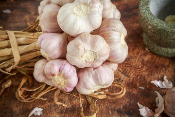 Garlic organic and mortar on wooden background