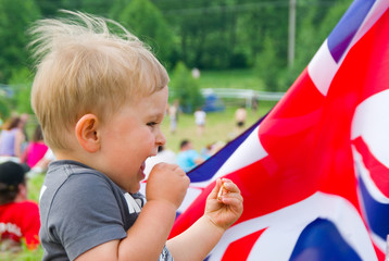 Baby boy during open-air festival on british flag background - 88478702