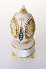 Decorative easter egg for jewellery (Faberge egg) on background