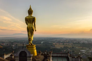 Foto op Plexiglas Sunrise, Golden buddha statue in Khao Noi temple, Nan Province, Thailand © Southtownboy Studio