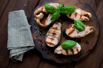 Grilled dog-salmon fillets with sea salt, pepper and green basil