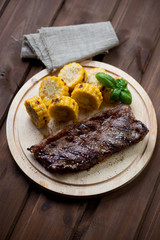 Grilled black angus steak striploin with sweet corncob slices