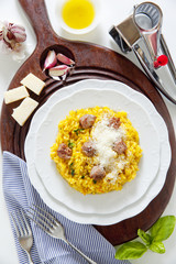 yellow saffron risotto with homemade sausage Milanese. Italian h