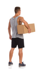 Man Holding Box Under His Arm. Back Side View