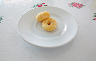 Fresh donuts on  white ceramic plate