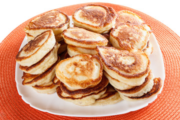 Obraz na płótnie Canvas Domestic, lush Pancakes on a plate, isolated white