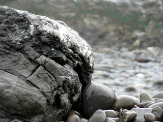 Fototapeta na wymiar Gray stone on background of sea water