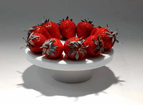 Ring of red strawberries on round plate