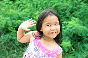 Portrait of cheerful kid. Smiling girl having fun outside. Happy successful person
