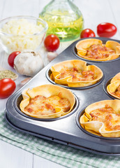 Homemade lasagna cups with minced meat, bolognese sauce topped with cheese